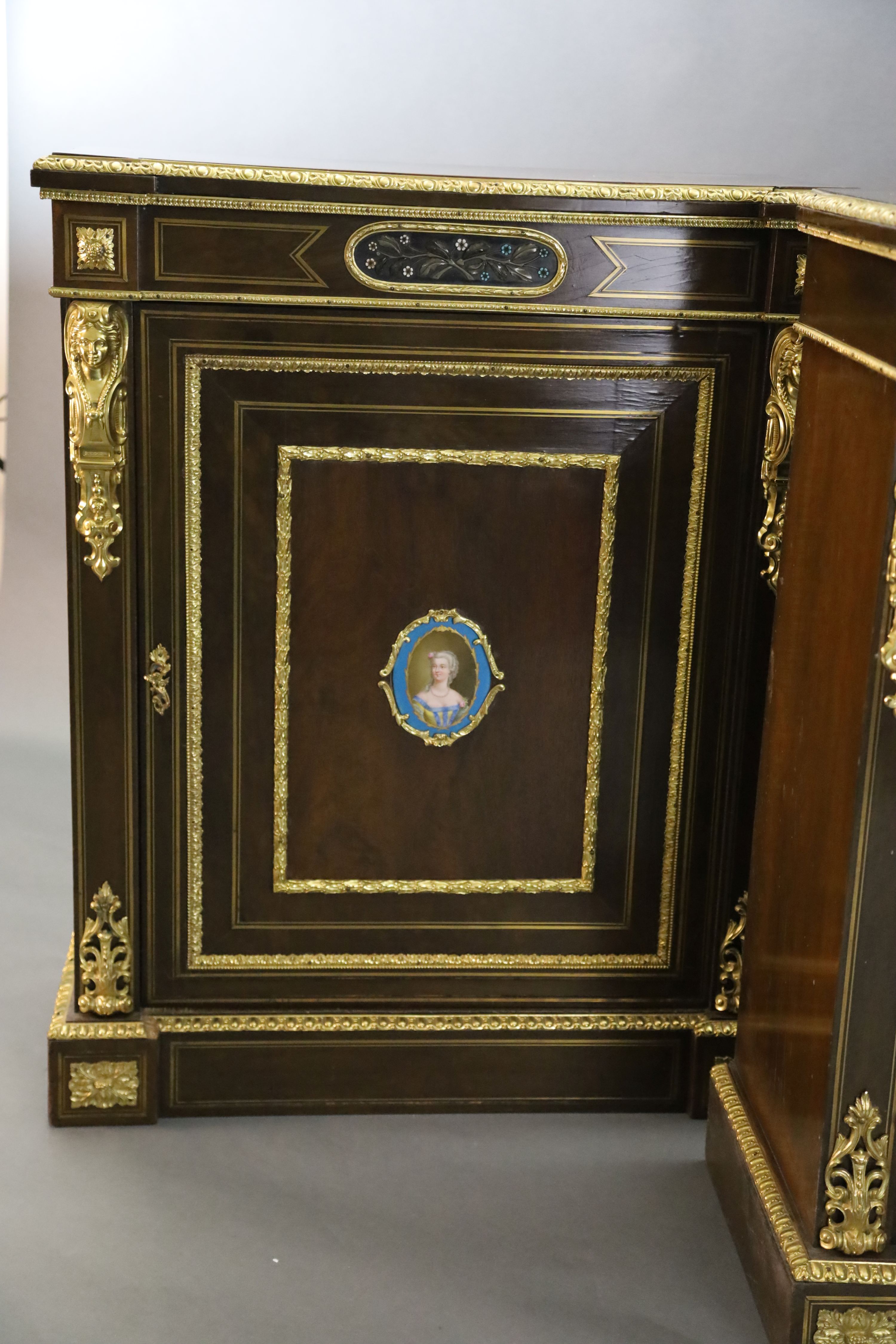 A pair of 19th century French ormolu mounted walnut pier cabinets, W.2ft 11in. D.1ft 4in. H.3ft 7in.